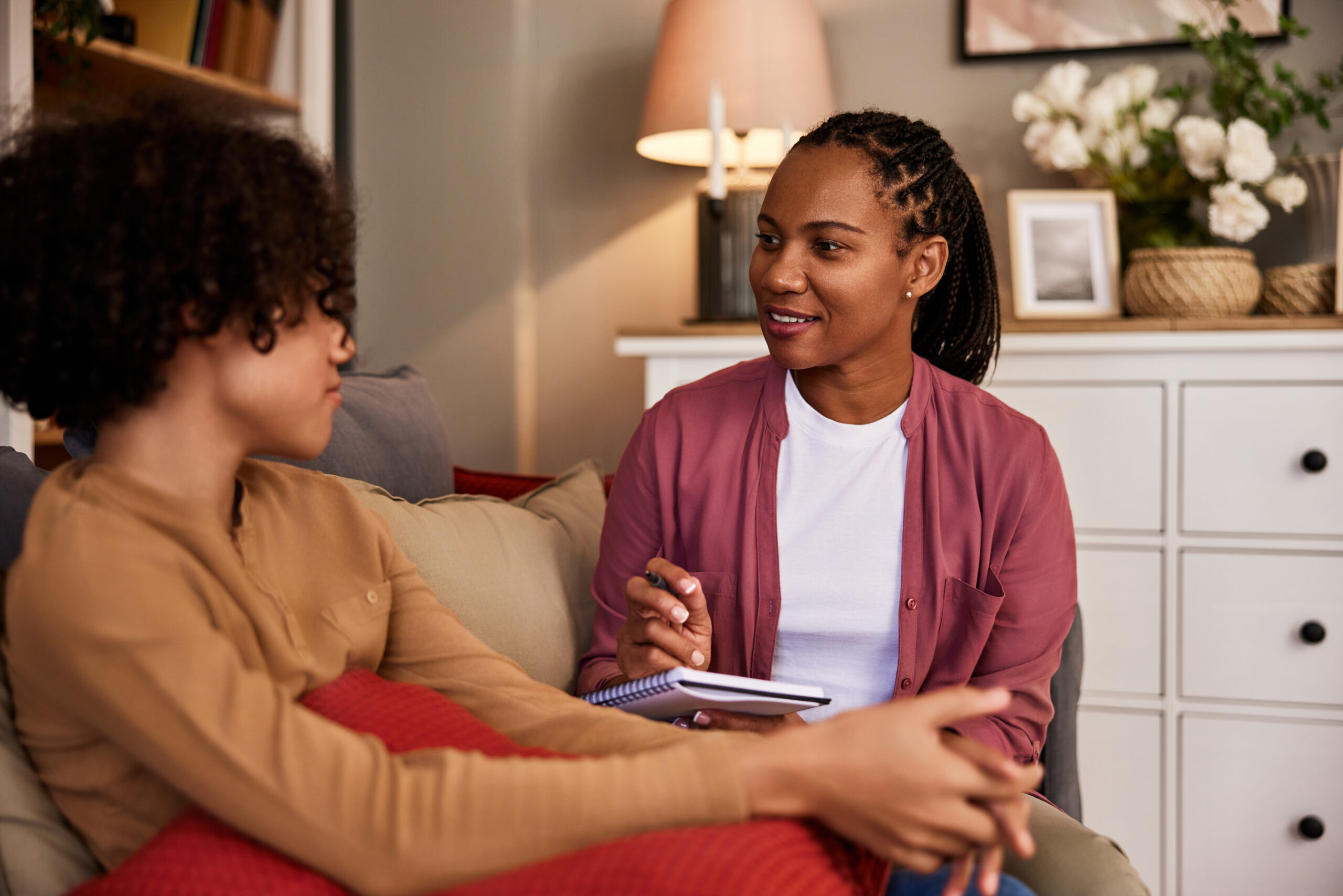 Two people in a warm, supportive conversation — genuine connection and guidance