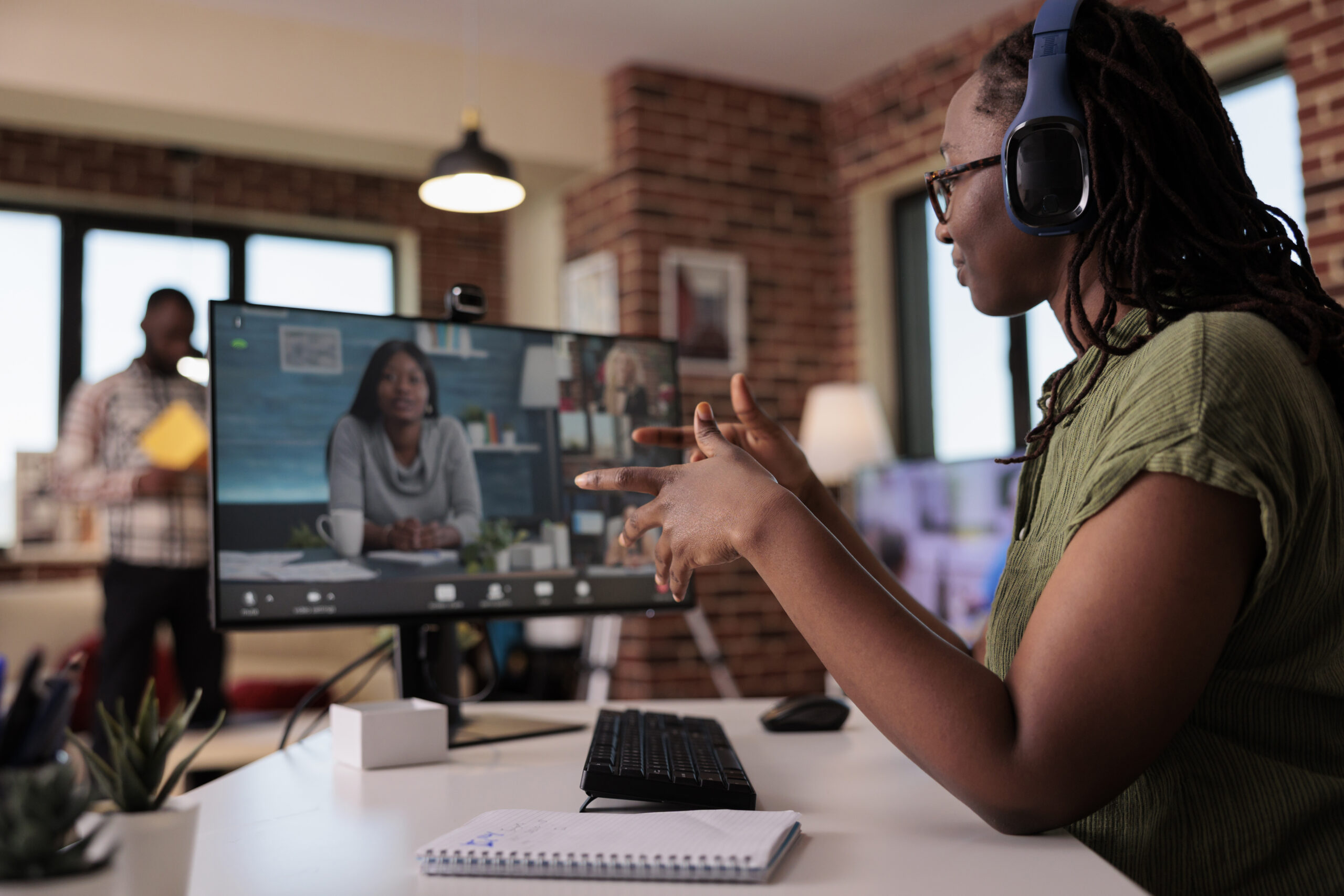Woman speaking on a virtual platform, engaged participants on screen