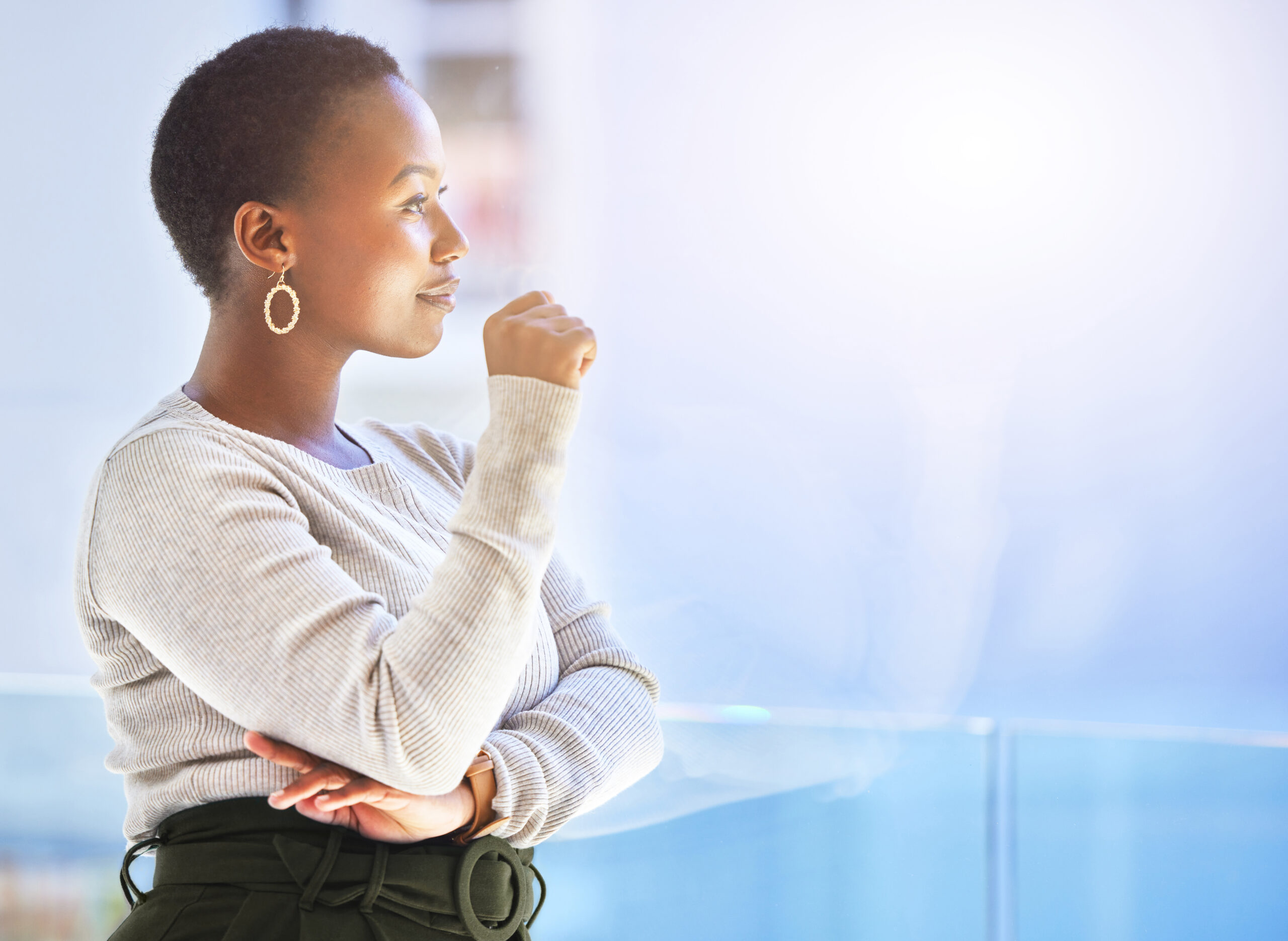 Woman standing in soft natural light — calm expression, symbolizing transition and hope