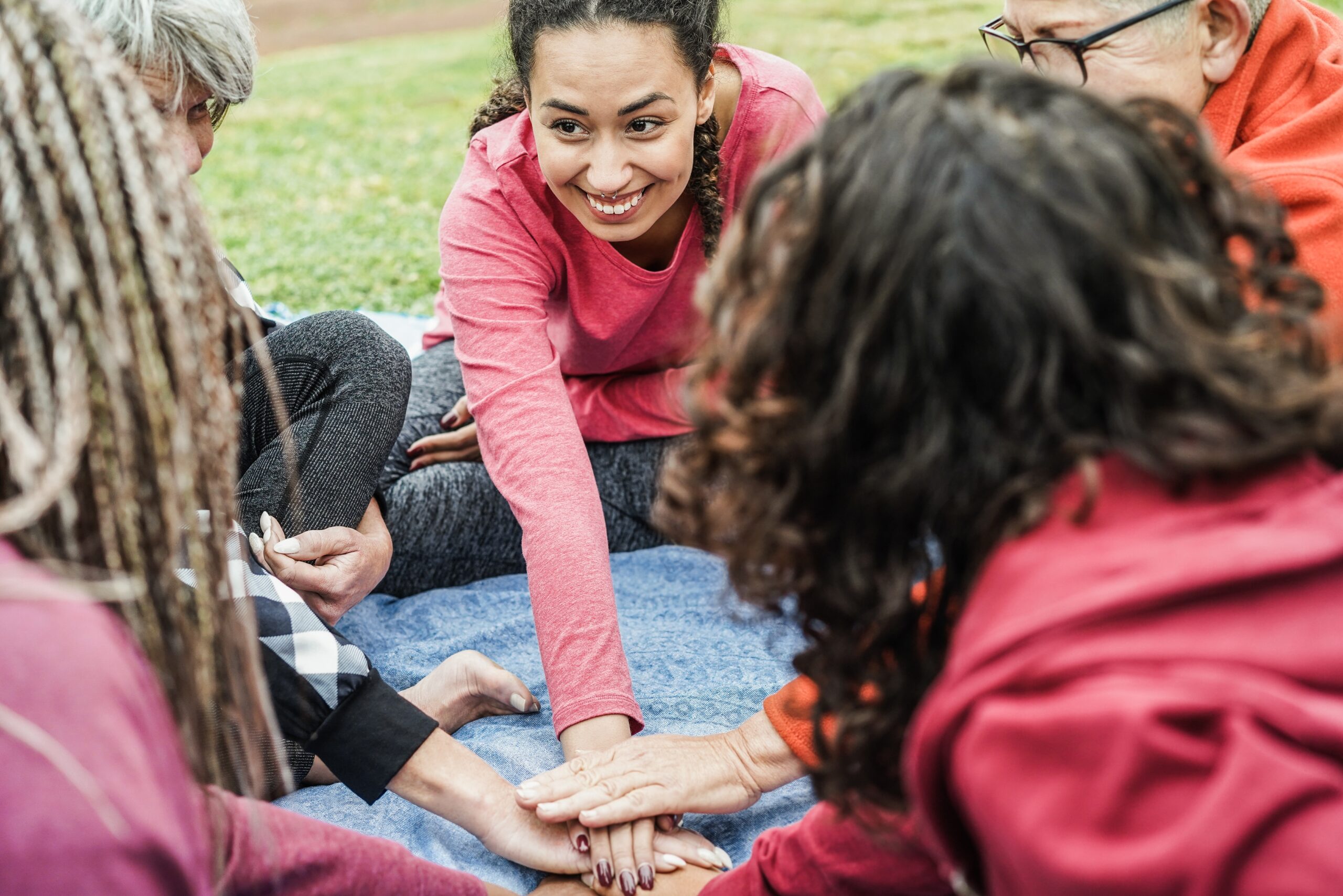 Women gathered in a warm, supportive group environment — connected and present