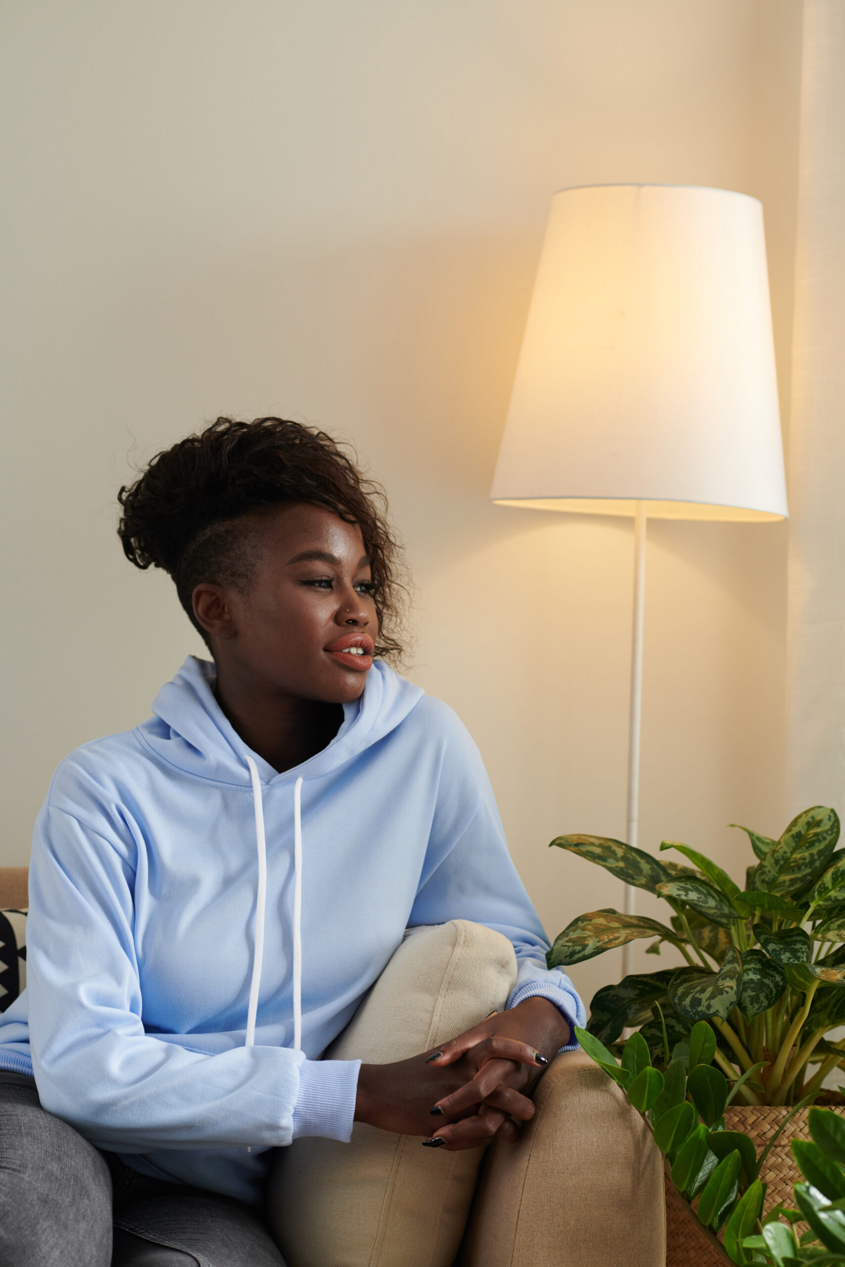 Woman sitting comfortably, peaceful expression — present and at ease
