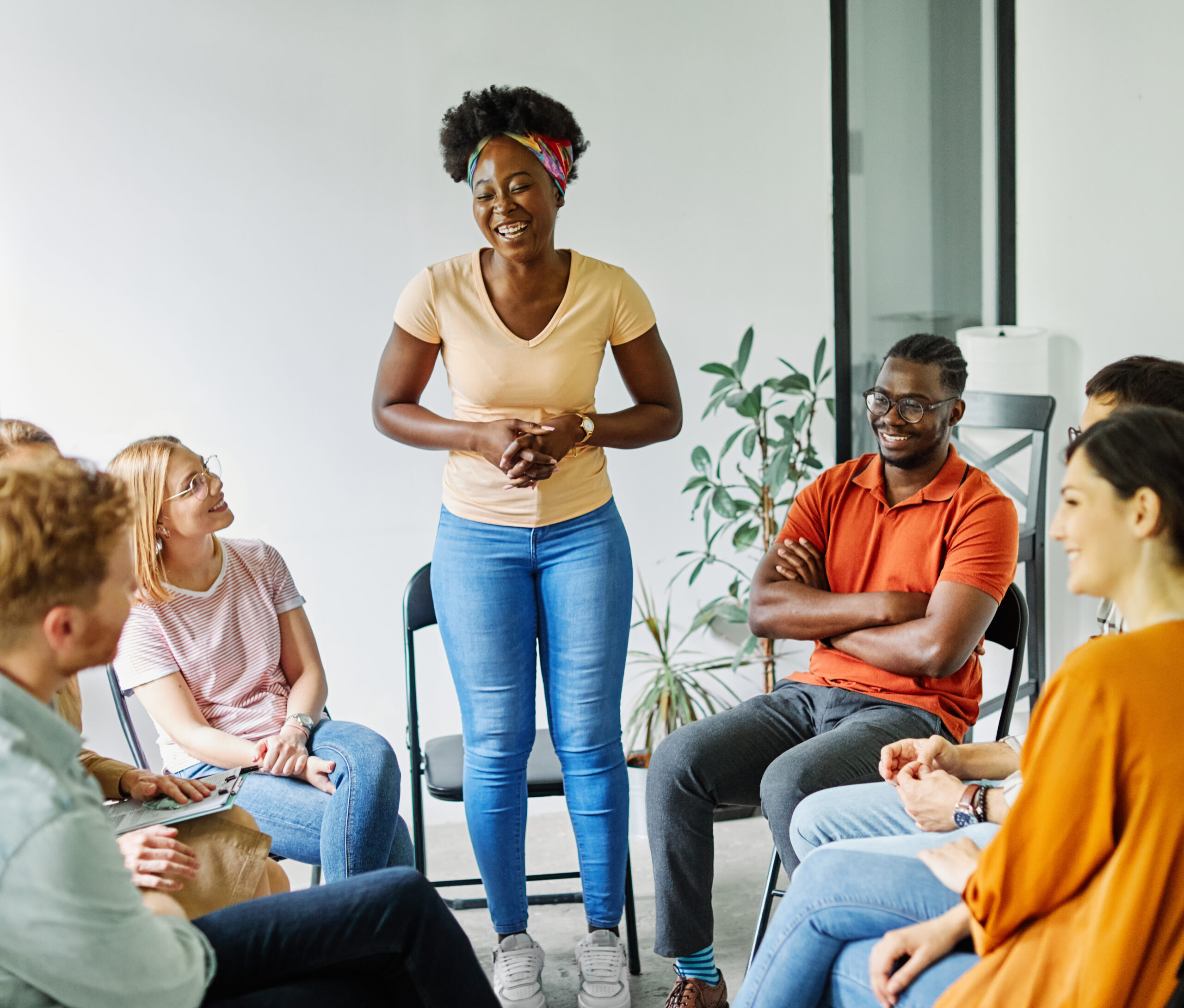 Woman presenting to a small engaged group in a community setting