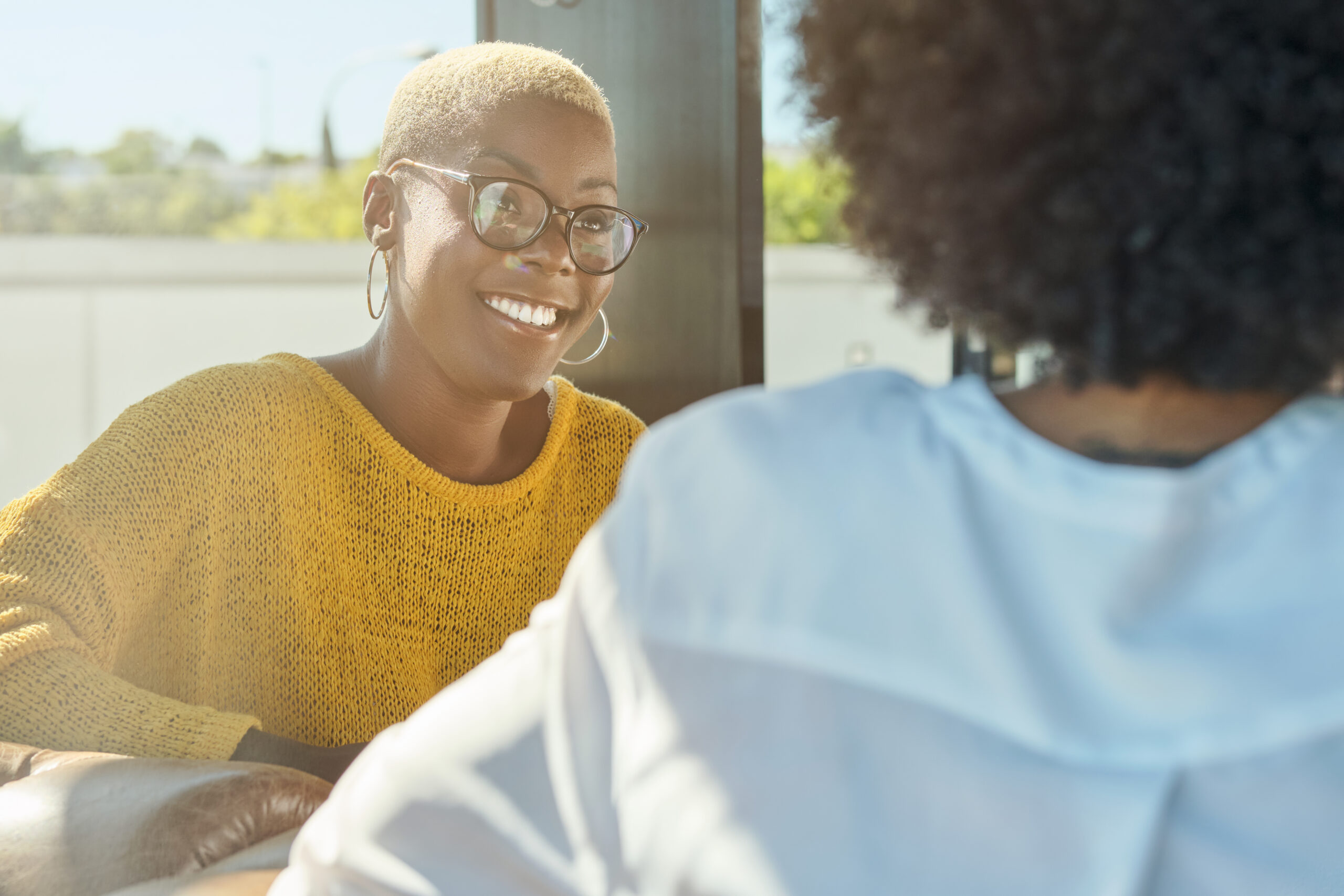 Two women in a warm, supportive mentorship setting