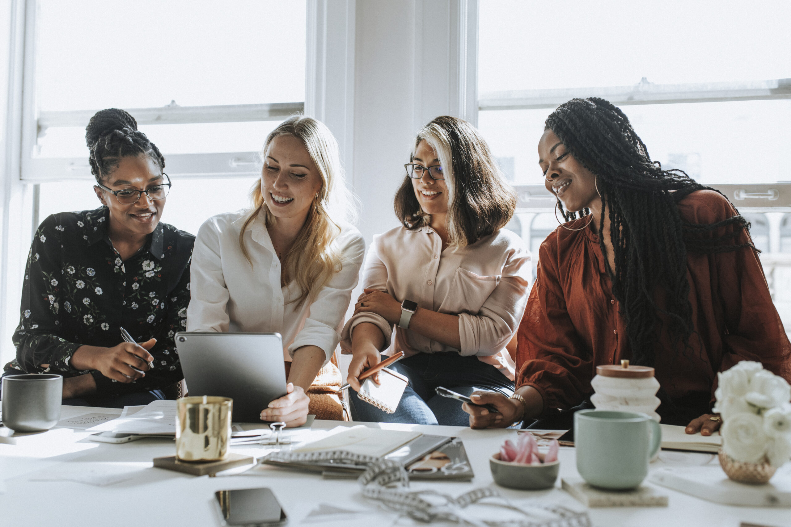 Women in a supportive, calm community environment — building something together